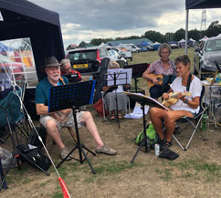 Ukulele Group playing outside at The Rustic Fayre
